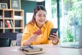 Young woman holding credit card and using laptop computer. Businesswoman working at cafe. Online shopping, e-commerce, internet Royalty Free Stock Photo