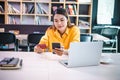 Young woman holding credit card and using laptop computer. Businesswoman working at cafe. Online shopping, e-commerce, internet Royalty Free Stock Photo