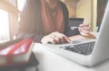 Young woman holding credit card and using laptop computer. Online shopping concept Royalty Free Stock Photo