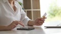 Young woman holding credit card and using smart phone for online shopping. Online payment shopping concept Royalty Free Stock Photo