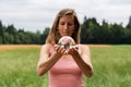 Young woman holding crystal ball in her hands