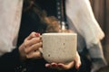 Young woman holding a Cup of hot tea outside