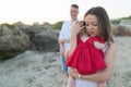 Young woman holding cute baby girl outdoors on the beach Royalty Free Stock Photo