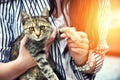 Young woman holding cute cat outdoor.Friendship. Love .Pets care