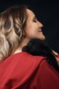 Young woman holding dog over a black background Royalty Free Stock Photo