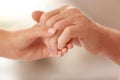 Young woman holding elderly man hand Royalty Free Stock Photo