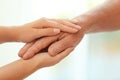 Young woman holding elderly man hand Royalty Free Stock Photo