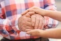 Young woman holding elderly man hands, closeup Royalty Free Stock Photo