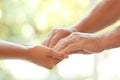 Young woman holding elderly man hands Royalty Free Stock Photo