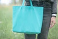 Young woman holding emerald green shopper bag Royalty Free Stock Photo