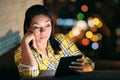 Young Woman Holding Ereader And Reading Ebook At Night