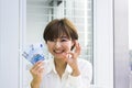 Young woman holding Euros