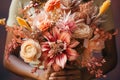 A young woman is holding a festive bouquet in her hands