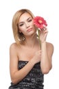 Young woman, holding a flower near her face Royalty Free Stock Photo