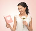 Young woman holding flower and postcard Royalty Free Stock Photo