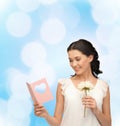 Young woman holding flower and postcard Royalty Free Stock Photo