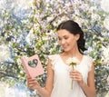 Young woman holding flower and postcard Royalty Free Stock Photo