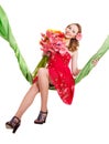 Young woman holding flowers on swing. Royalty Free Stock Photo