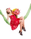 Young woman holding flowers on swing. Royalty Free Stock Photo