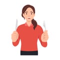 Young woman holding fork and knife. Hungry woman waiting for food. Royalty Free Stock Photo