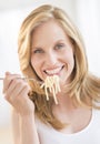 Young Woman Holding Fork With Pasta At Home Royalty Free Stock Photo