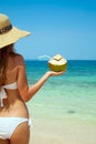 Woman Holding Fresh Coconut At Tropical Beach