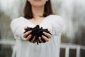 Young Woman Holding Fresh Healthy Compost in Her Hands