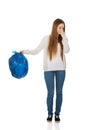 Young woman holding a full garbage bag. Royalty Free Stock Photo