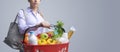 Young woman holding a full shopping basket Royalty Free Stock Photo