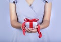 Young woman holding gift box in hands, giving gift box Royalty Free Stock Photo