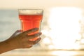 Young woman holding a glass of beer. Beach on the beach with sun Royalty Free Stock Photo