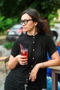 Young woman holding glass with fresh cold fruit drink outdoors. Detox water with berries. Healthy lifestyle and diet