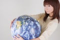 Young woman holding globe Royalty Free Stock Photo