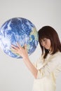 Young woman holding globe Royalty Free Stock Photo