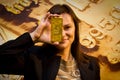 Business woman holding a gold bar