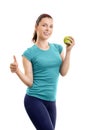 Young woman holding green apple and giving thumb up Royalty Free Stock Photo