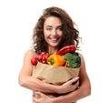 Young woman holding grocery paper shopping bag full of fresh veg Royalty Free Stock Photo