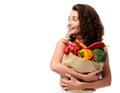 Young woman holding grocery paper shopping bag full of fresh vegetables. Diet healthy eating concept Royalty Free Stock Photo