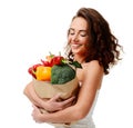 Young woman holding grocery paper shopping bag full of fresh vegetables. Diet healthy eating concept Royalty Free Stock Photo