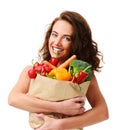 Young woman holding grocery paper shopping bag full of fresh vegetables. Diet healthy eating concept Royalty Free Stock Photo