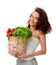 Young woman holding grocery paper shopping bag full of fresh vegetables. Diet healthy eating concept Royalty Free Stock Photo