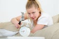 Young woman holding hammer and alarm clock Royalty Free Stock Photo