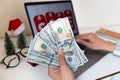 Young woman holding hand cash money one hundred dollars bills, holiday shopping. Person using technology Royalty Free Stock Photo