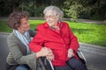 Young woman holding hand of old lady sitting in wheelchair Royalty Free Stock Photo