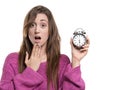 Young woman holding a hand to her mouth, and holding a watch at six o clock Royalty Free Stock Photo