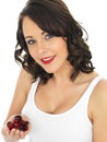 Young Woman Holding a Handful of Fresh Cranberries