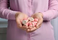 Young woman holding handful of tasty jelly candies