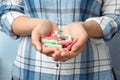 Young woman holding handful of tasty jelly candies