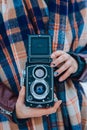 Young woman holding in hands old vintage camera. Girl photographer Royalty Free Stock Photo