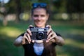 Young woman holding in hands old vintage camera Royalty Free Stock Photo